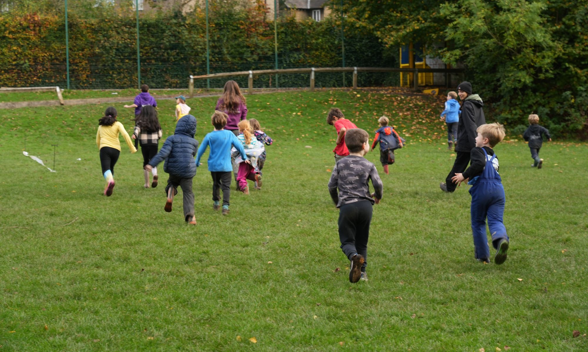 A group of children and staff taking part in a race.