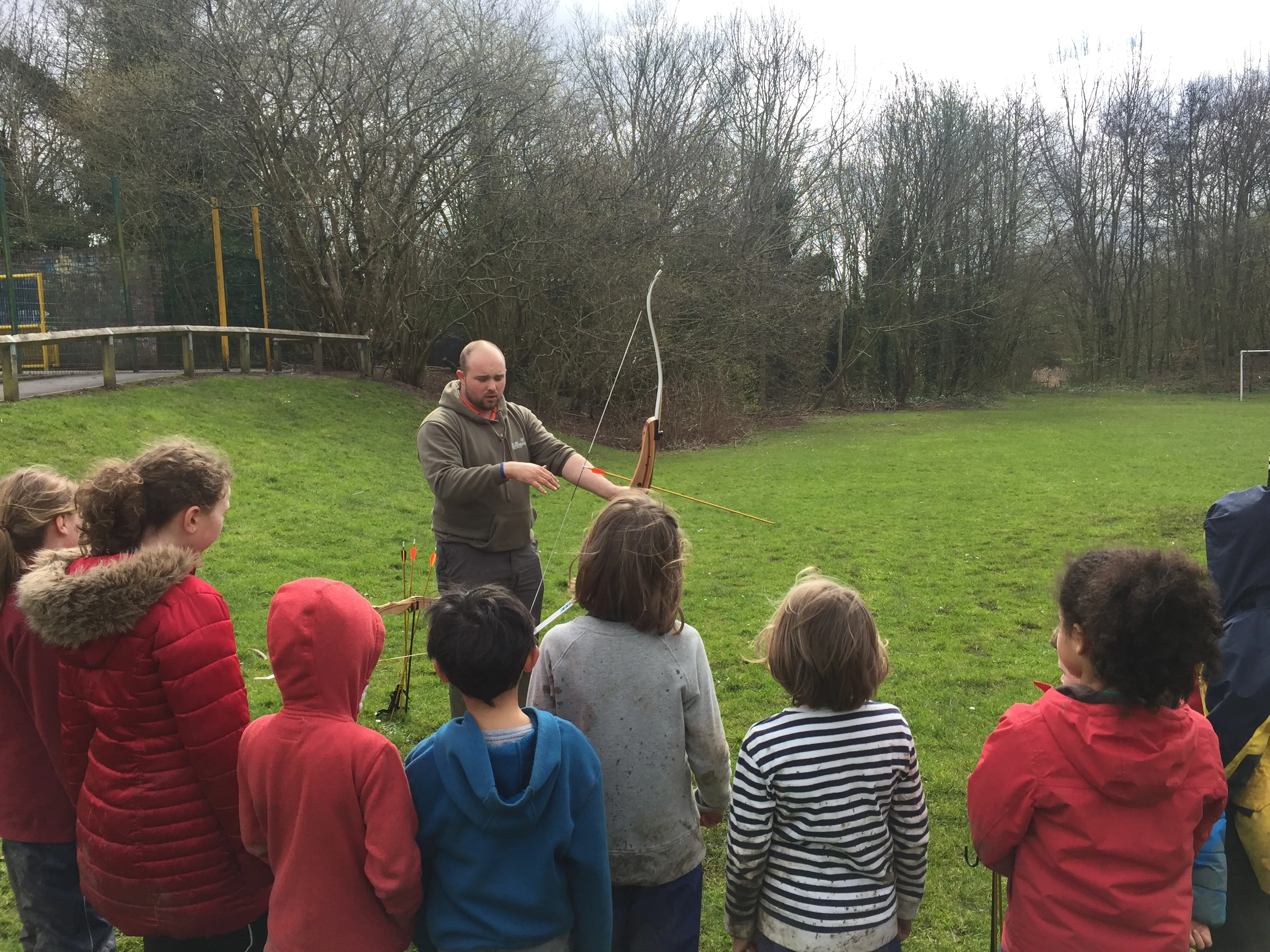 Staff member doing a demonstration of archery.
